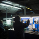 An employee checks the quality of glass bottles on the production line.